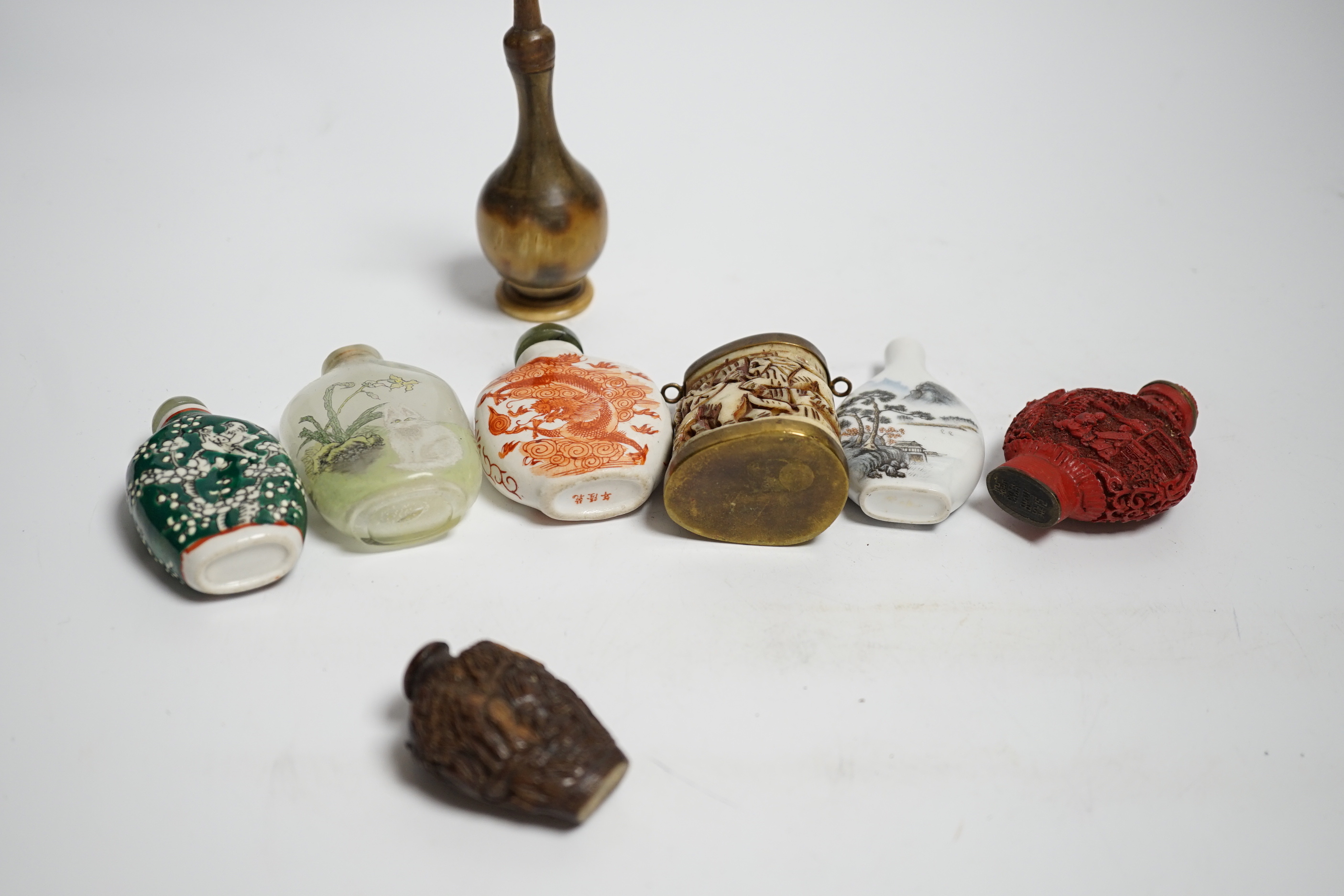 Seven various Chinese snuff bottles including horn, simulated lacquer, porcelain, glass, wood and a small bone powder flask